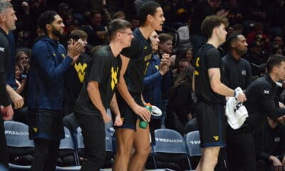 WVU Basketball bench with Kerr Kriisa and Jesse Edwards