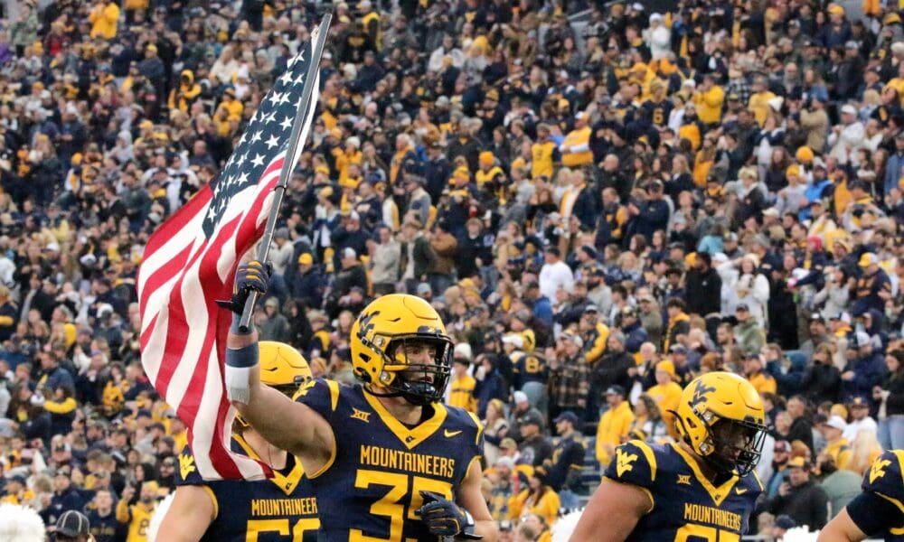 WVU Football Reid Carrico with US flag