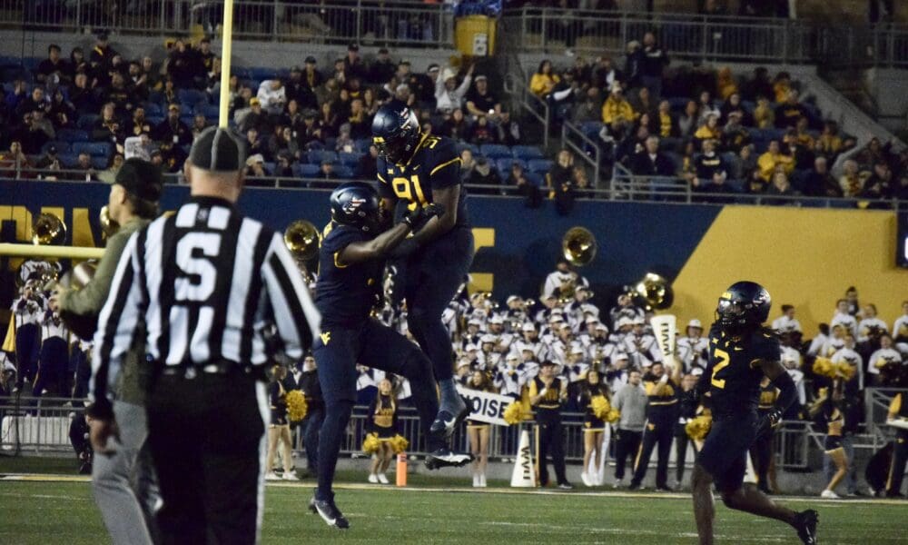 WVU Football Defense with Sean Martin and Aubrey Burks celebrates over BYU