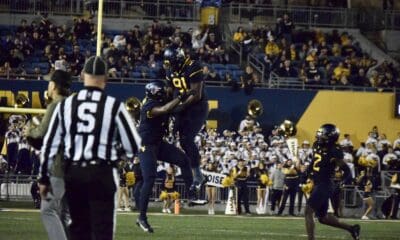 WVU Football Defense with Sean Martin and Aubrey Burks celebrates over BYU