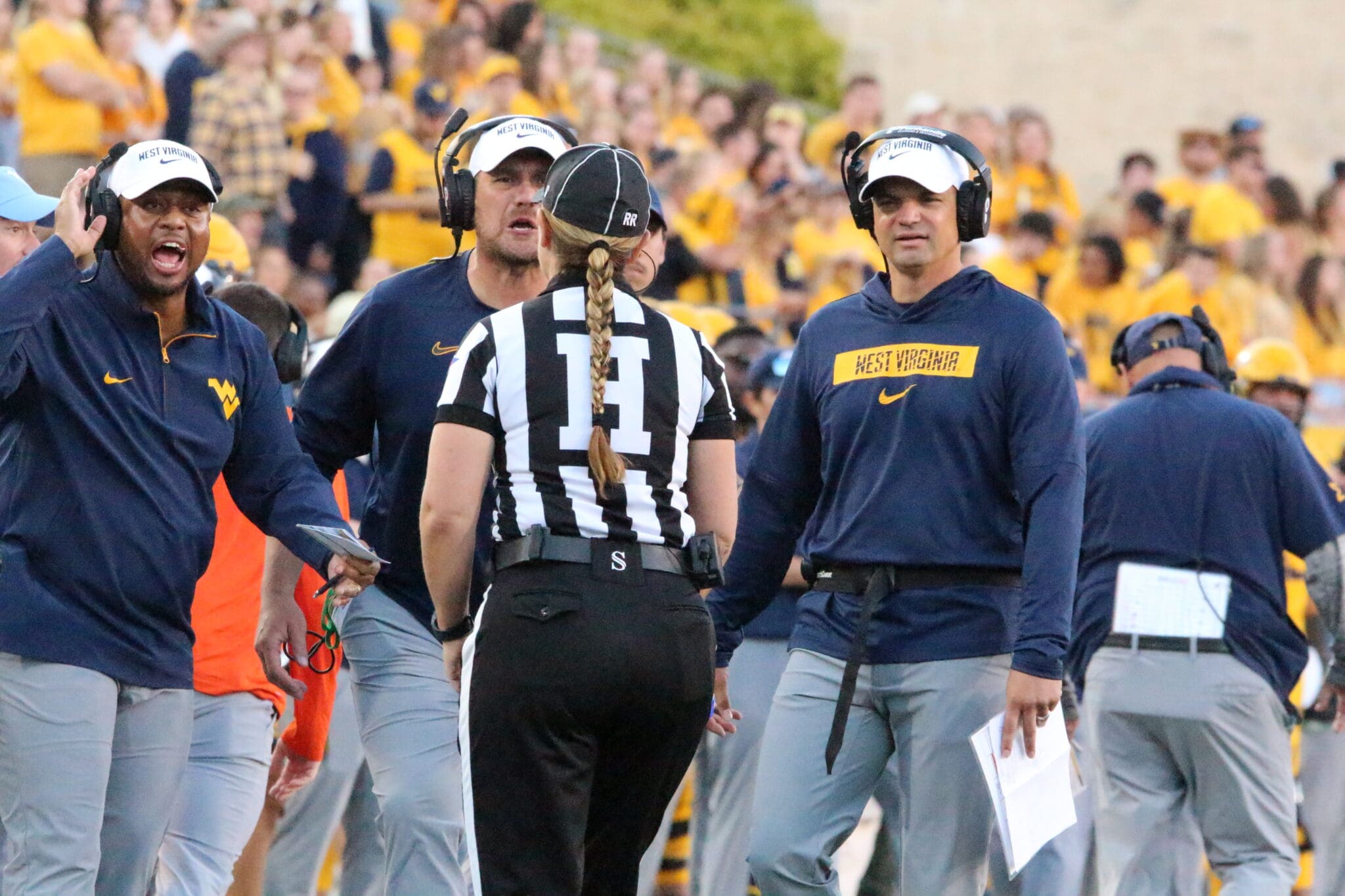 WVU HC Neal Brown and coaches Victor Cabral and ShaDon Brown