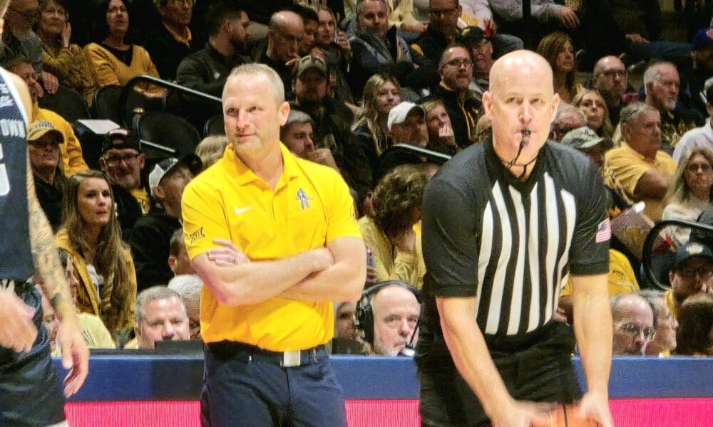 WVU Basketball HC Darian DeVries and ref