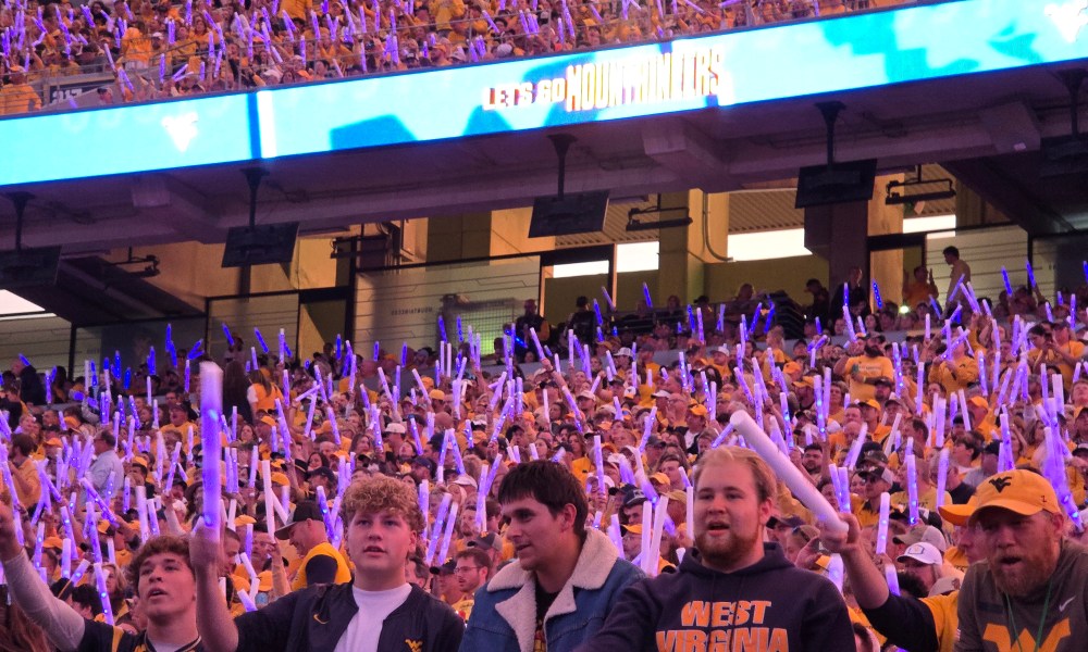 WVU Football crowd at night game stock