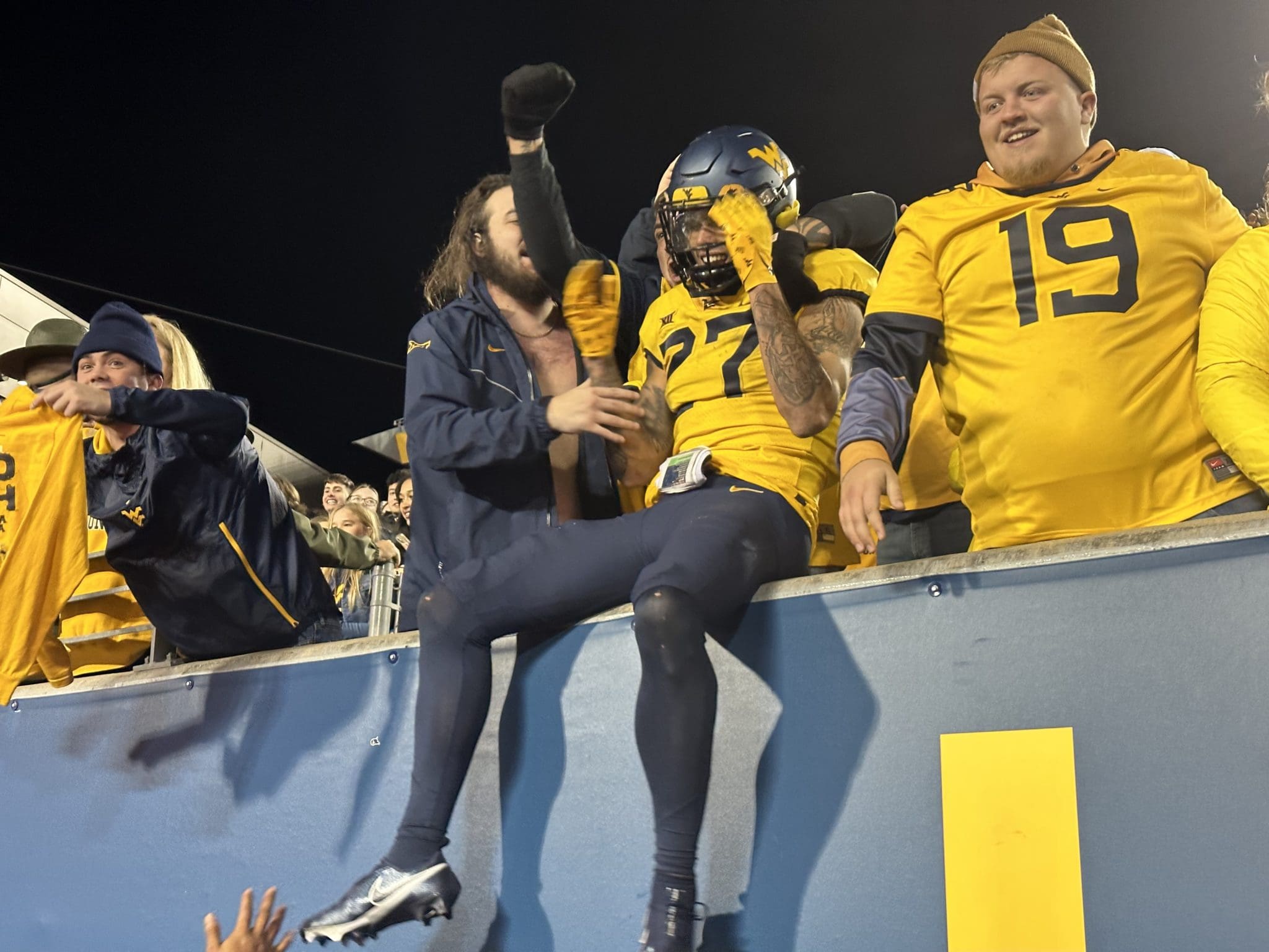 WVU Football Safety Davis Mallinger celebrates the win with fans