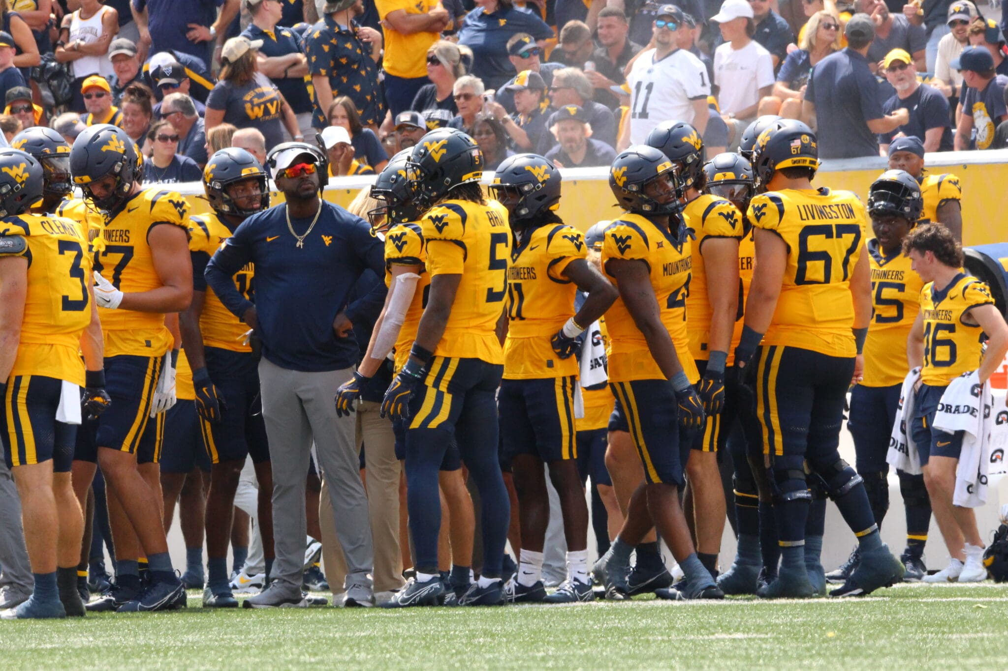 WVU Football WR Coach Bilal Marshall and receivers on sideline stock photo