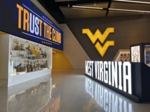West Virginia sign at WVU Football facility with trophies stock