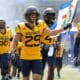 WVU Football Preston Fox carrying flag