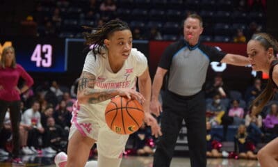 WVU Women's Basketball guard JJ Quinerly dribbles the ball during the Mountaineers' February 17 game against No. 23 Oklahoma.