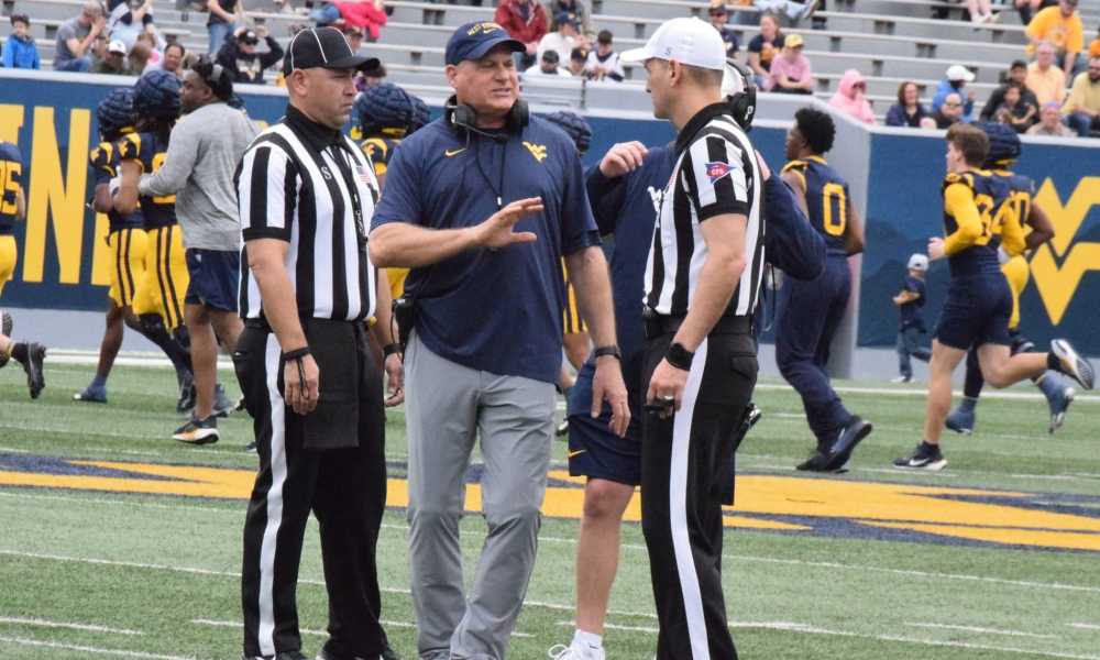 WVU Football HC Rich Rodriguez with refs during Spring Showcase