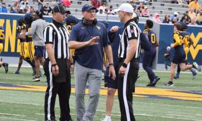 WVU Football HC Rich Rodriguez with refs during Spring Showcase