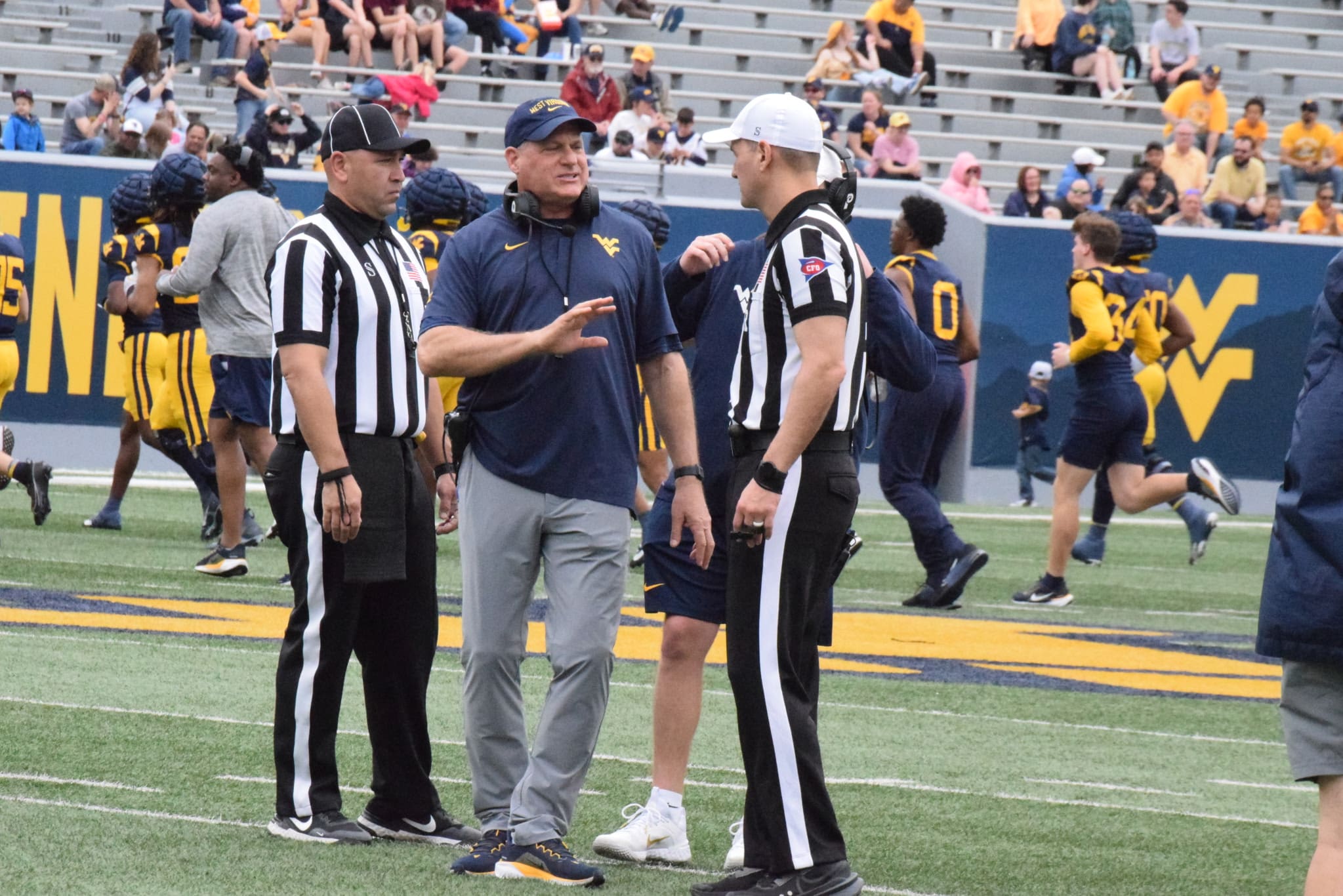 WVU Football HC Rich Rodriguez with refs during Spring Showcase