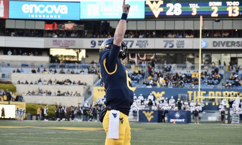 WVU Football QB Garrett Greene celebrates a TD by pointing sky against Cincinnati