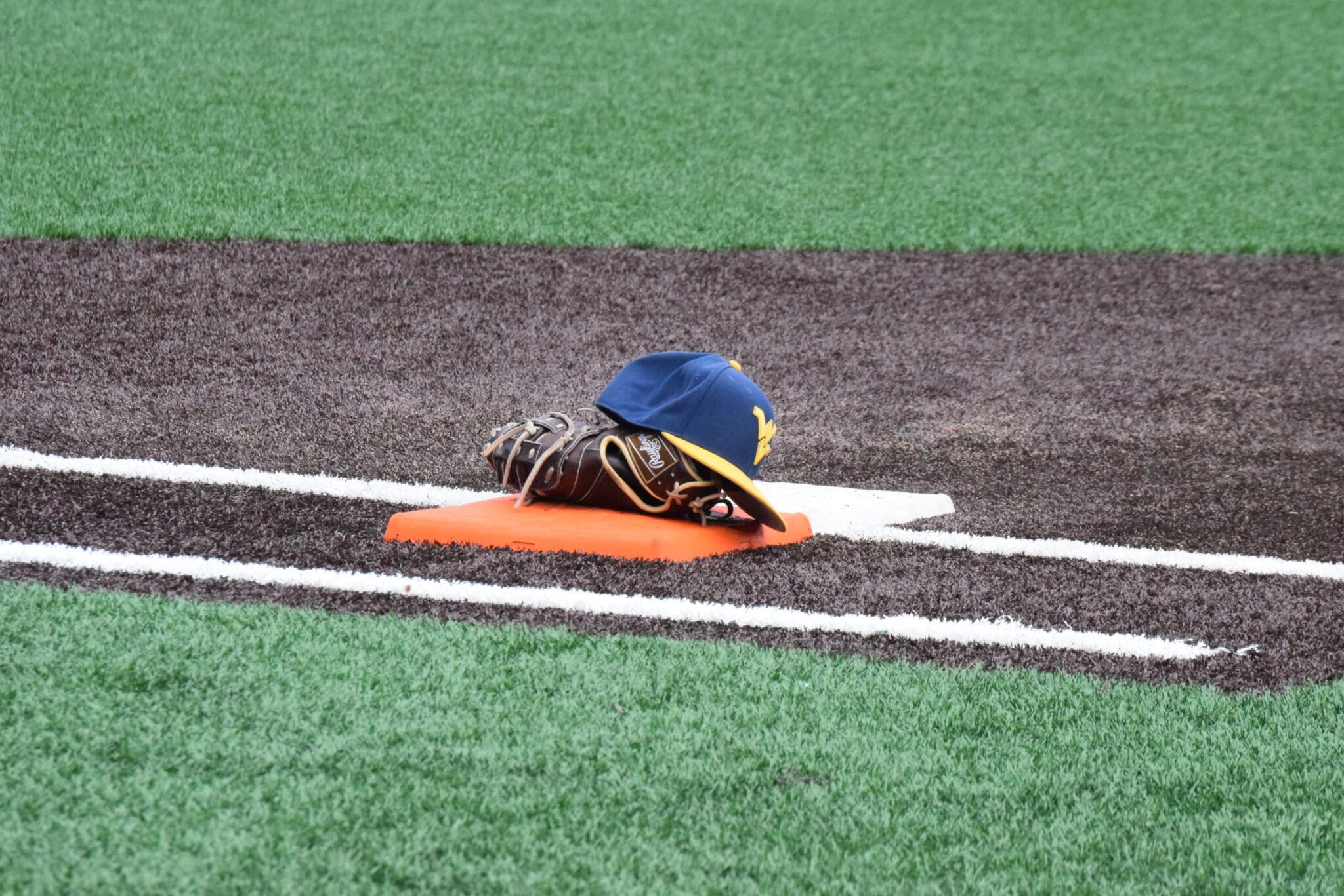 WVU Baseball hat and glove stock
