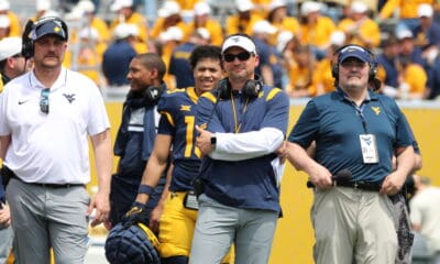 WVU Football head coach Neal Brown and OLB coach Victor Cabral