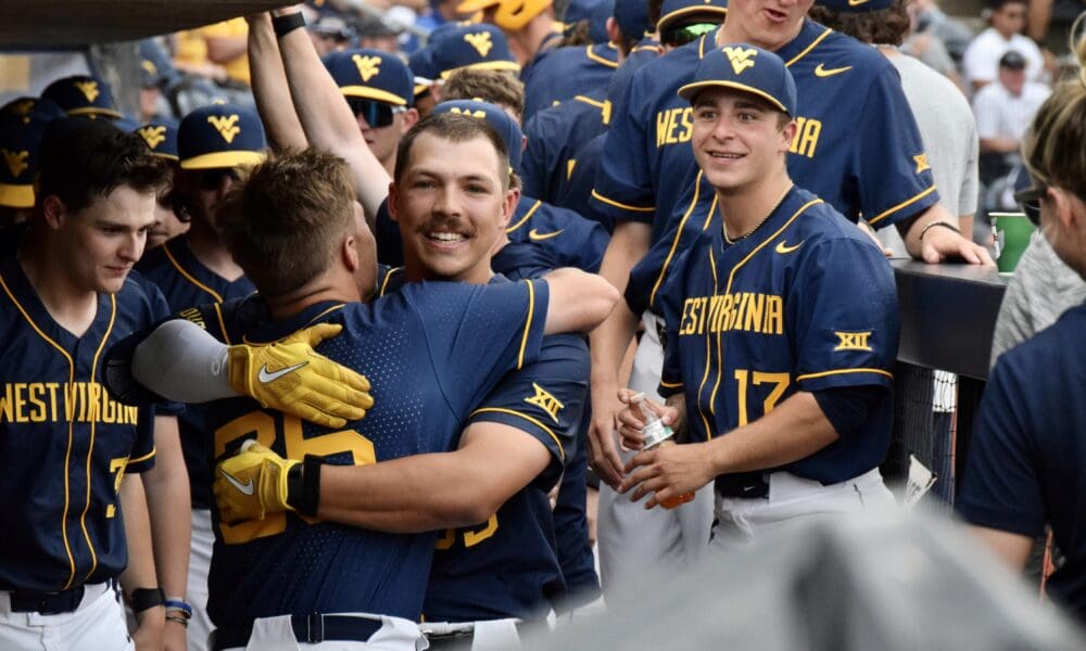 WVU Baseball celebrates Kyle West home run in the dugout