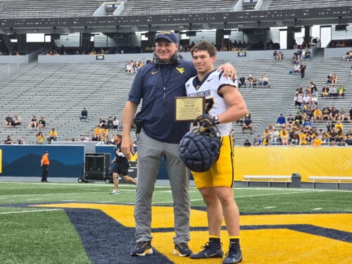 WVU Football HC Rich Rodriguez with RB Clay Ash and award