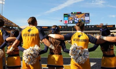 WVU cheerleaders on football field stock