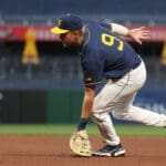 WVU Baseball first baseman Grant Hussey stretches to pick a ball.