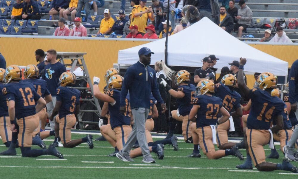 WVU Football Coach Noel Devine during warmups