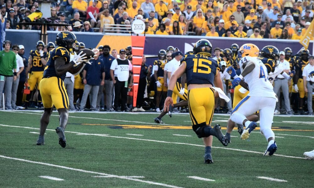 WVU Football QB Scotty Fox Jr. tosses the ball to RB Tye Edwards