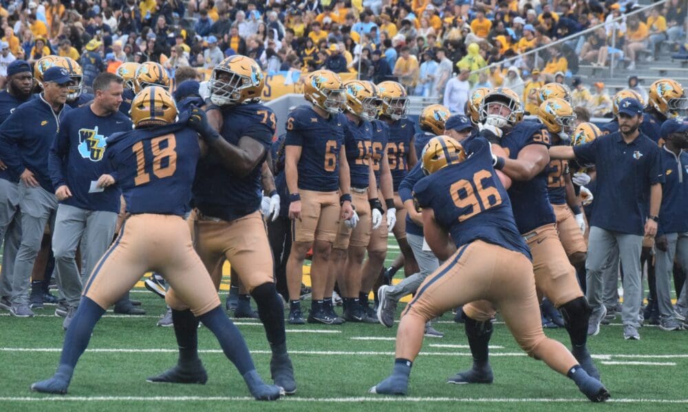 WVU Football players getting ready before Utah game