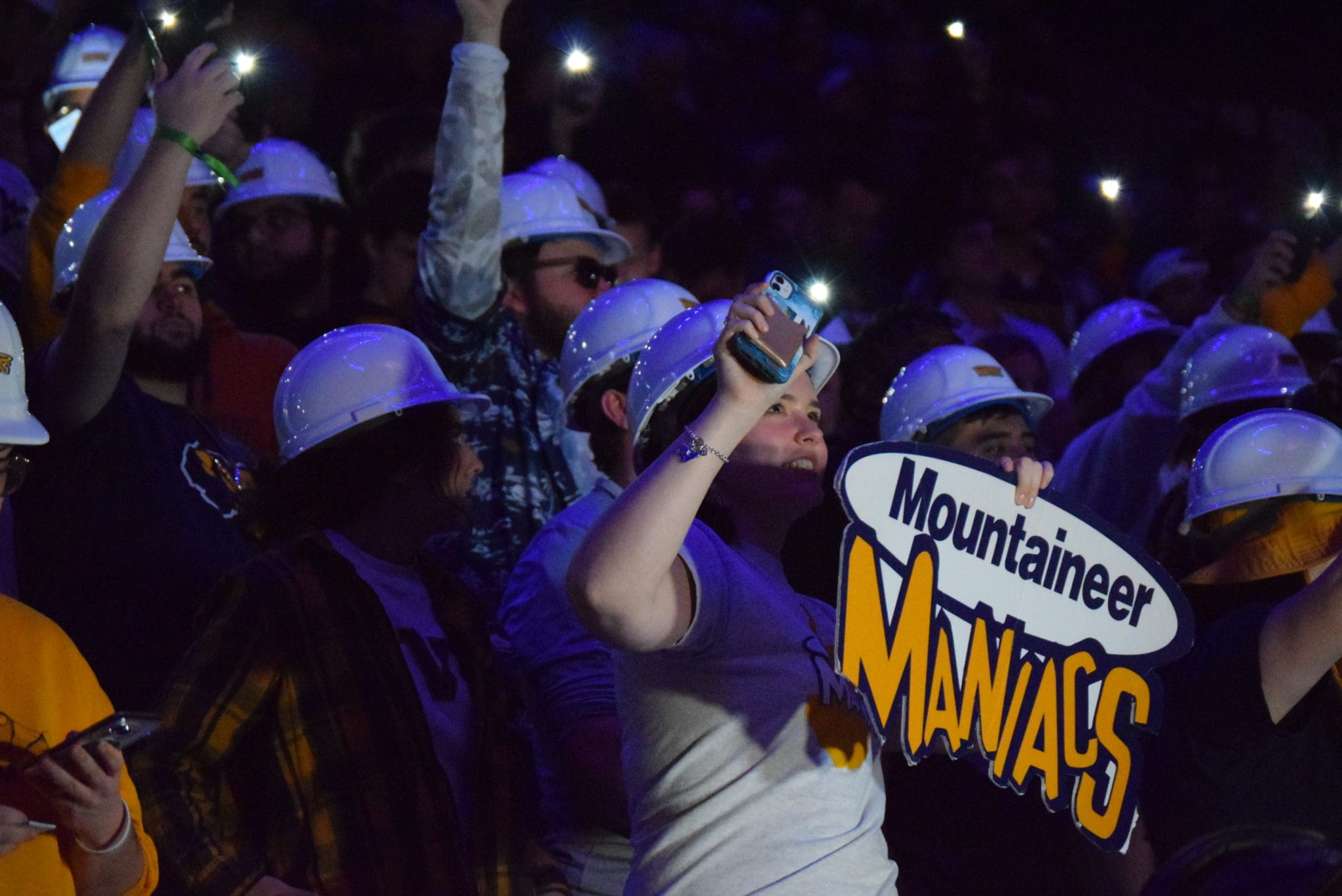 WVU fans with Maniacs sign