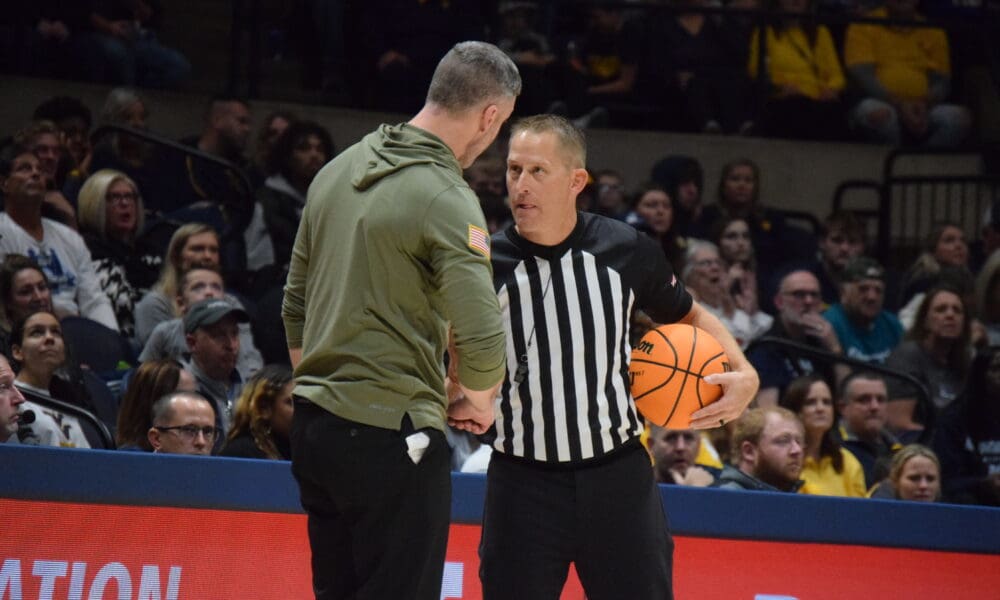 WVU Basketball Josh Eilert and Referee