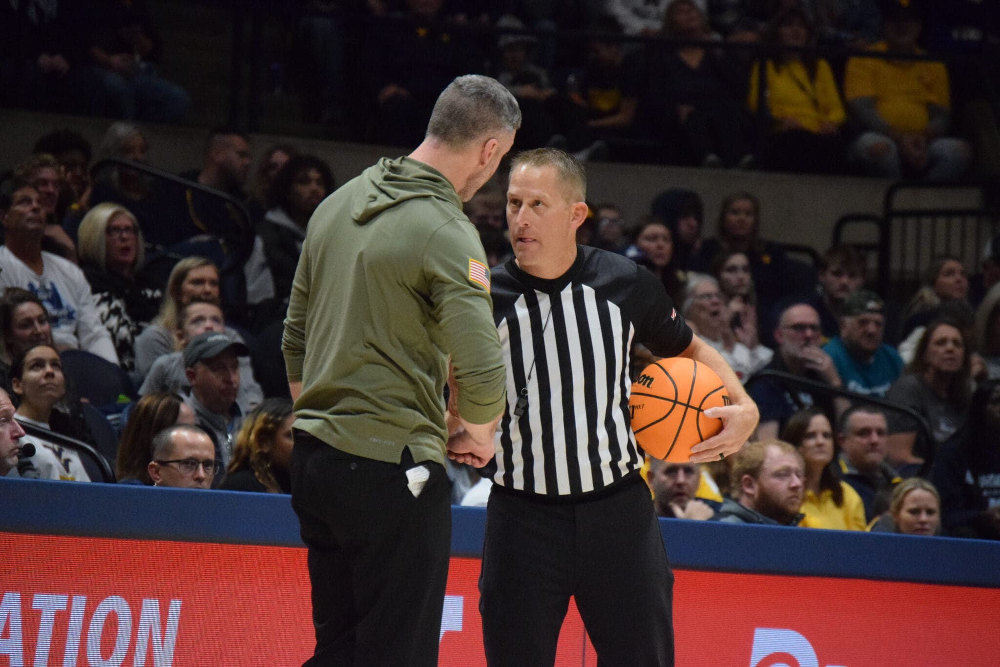 WVU Basketball Josh Eilert and Referee