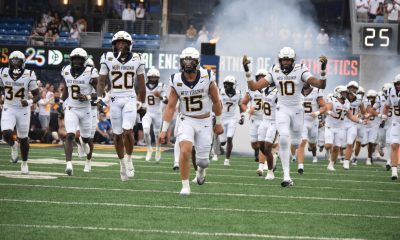 WVU Football team running out of tunnel stock