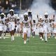 WVU Football team running out of tunnel stock