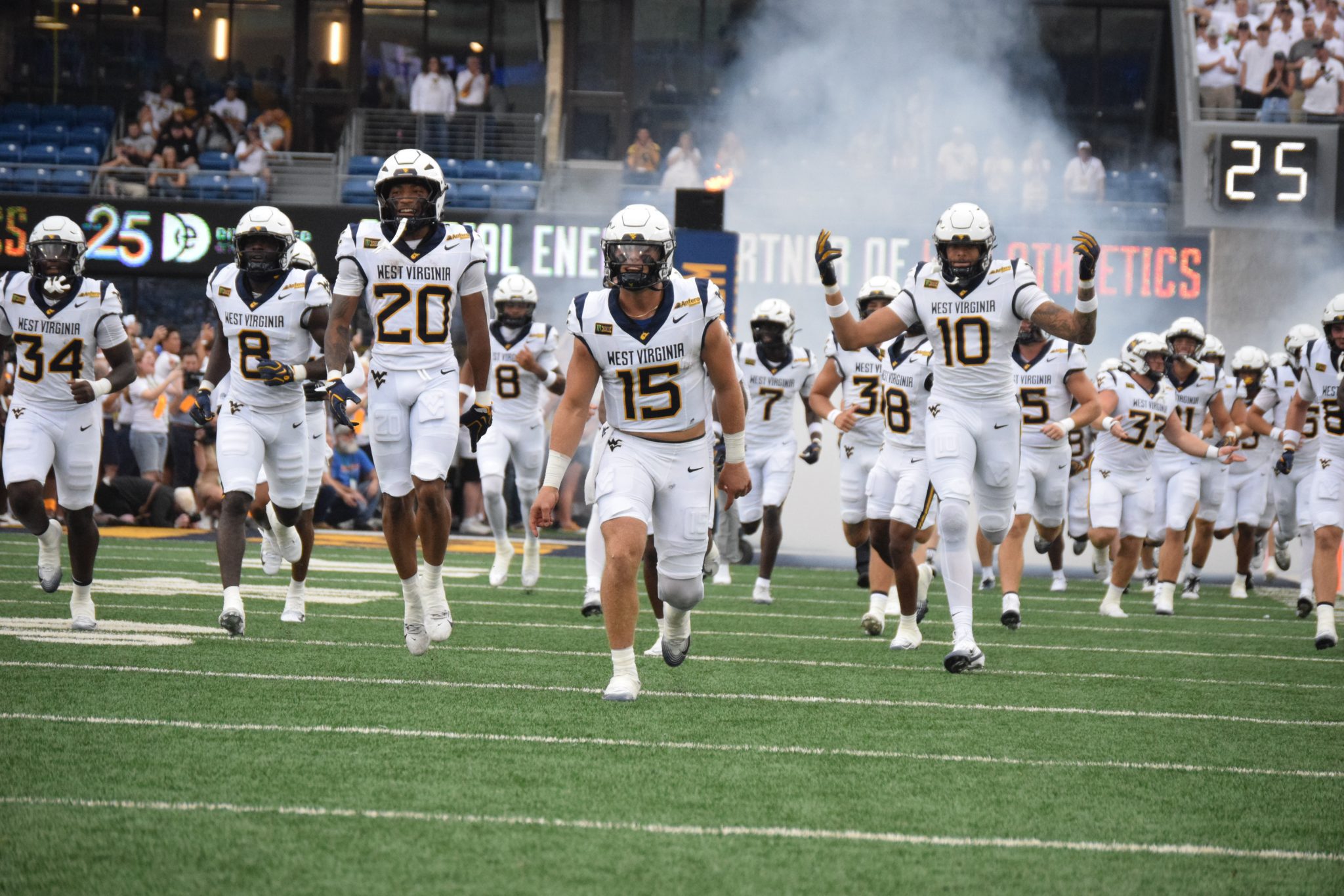 WVU Football team running out of tunnel stock