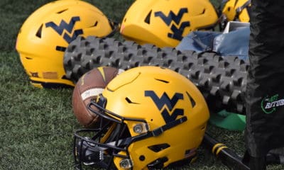 WVU Gold Helmets and Football stock