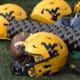 WVU Gold Helmets and Football stock
