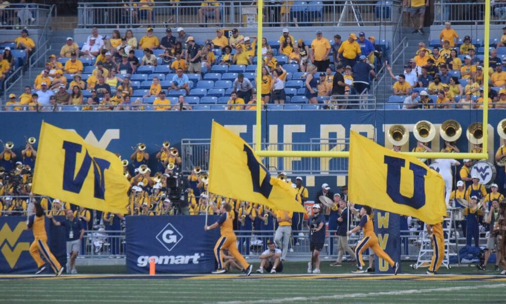 WVU Football flag on field after touchdown stock