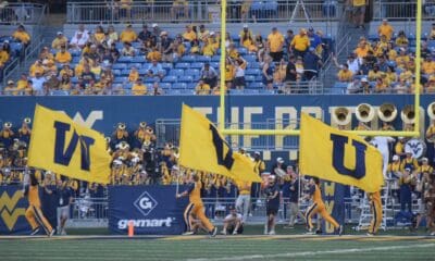 WVU Football flag on field after touchdown stock