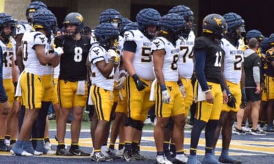 WVU Football Jaylen Henderson and Nicco Marchiol with team at spring showcase
