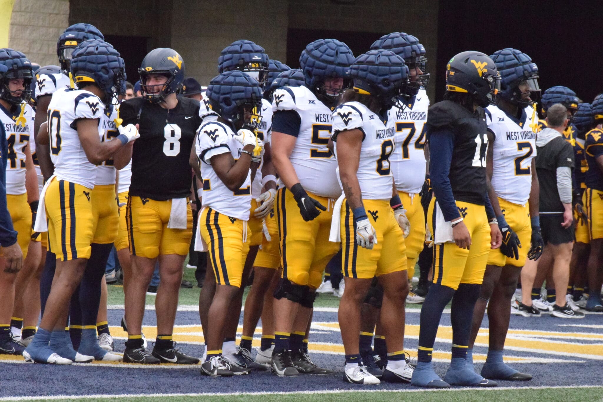 WVU Football Jaylen Henderson and Nicco Marchiol with team at spring showcase