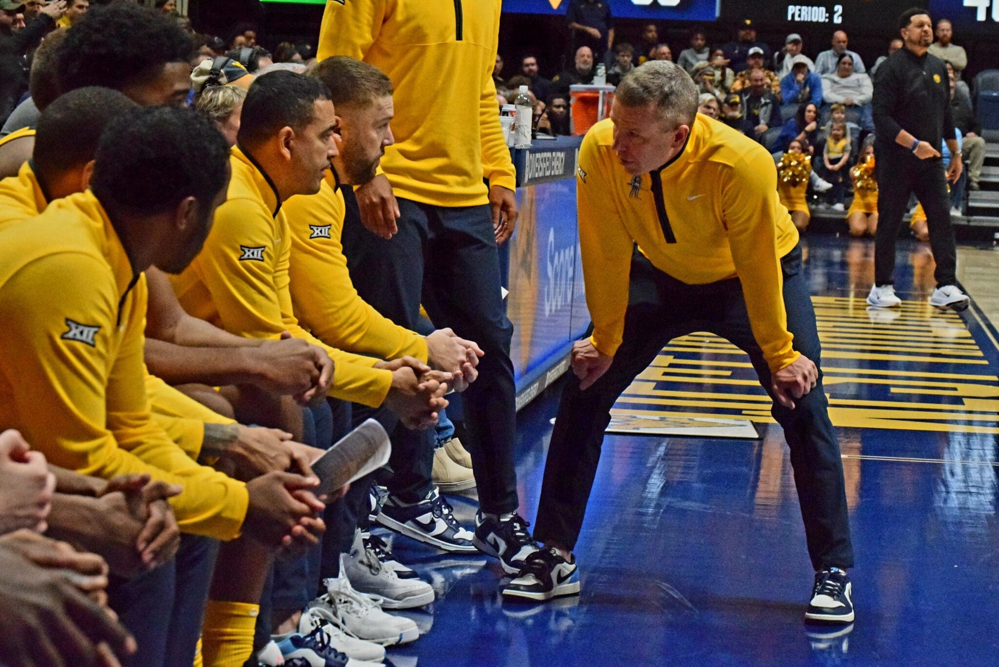 WVU Basketball HC Ross Hodge in huddle