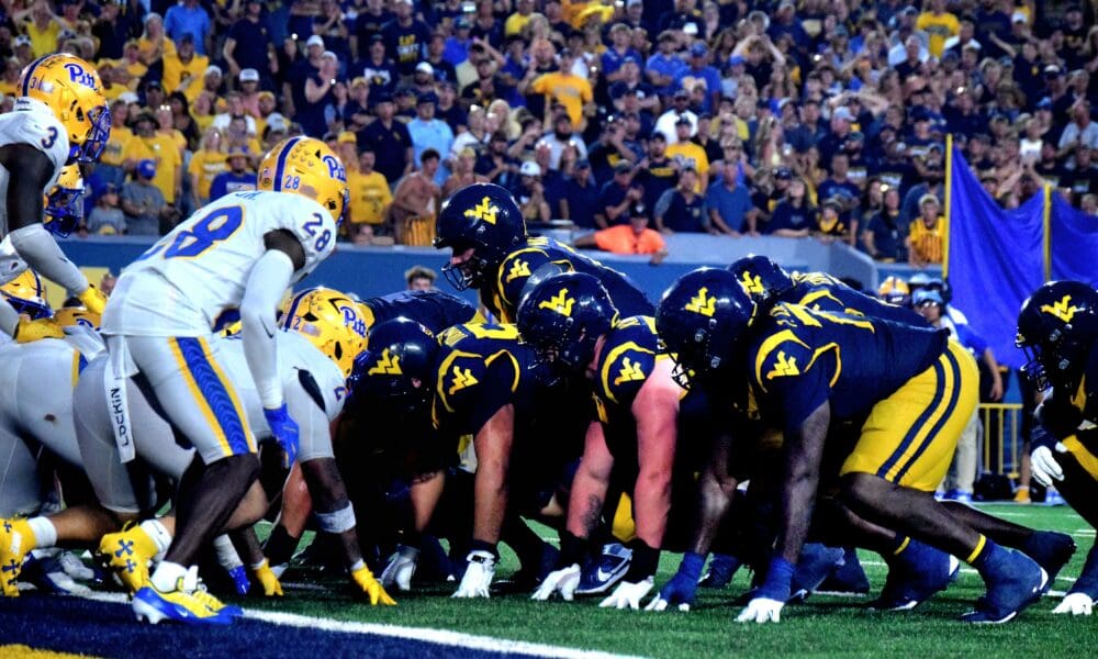 WVU Football offense lines up near end zone against Pitt in Backyard Brawl