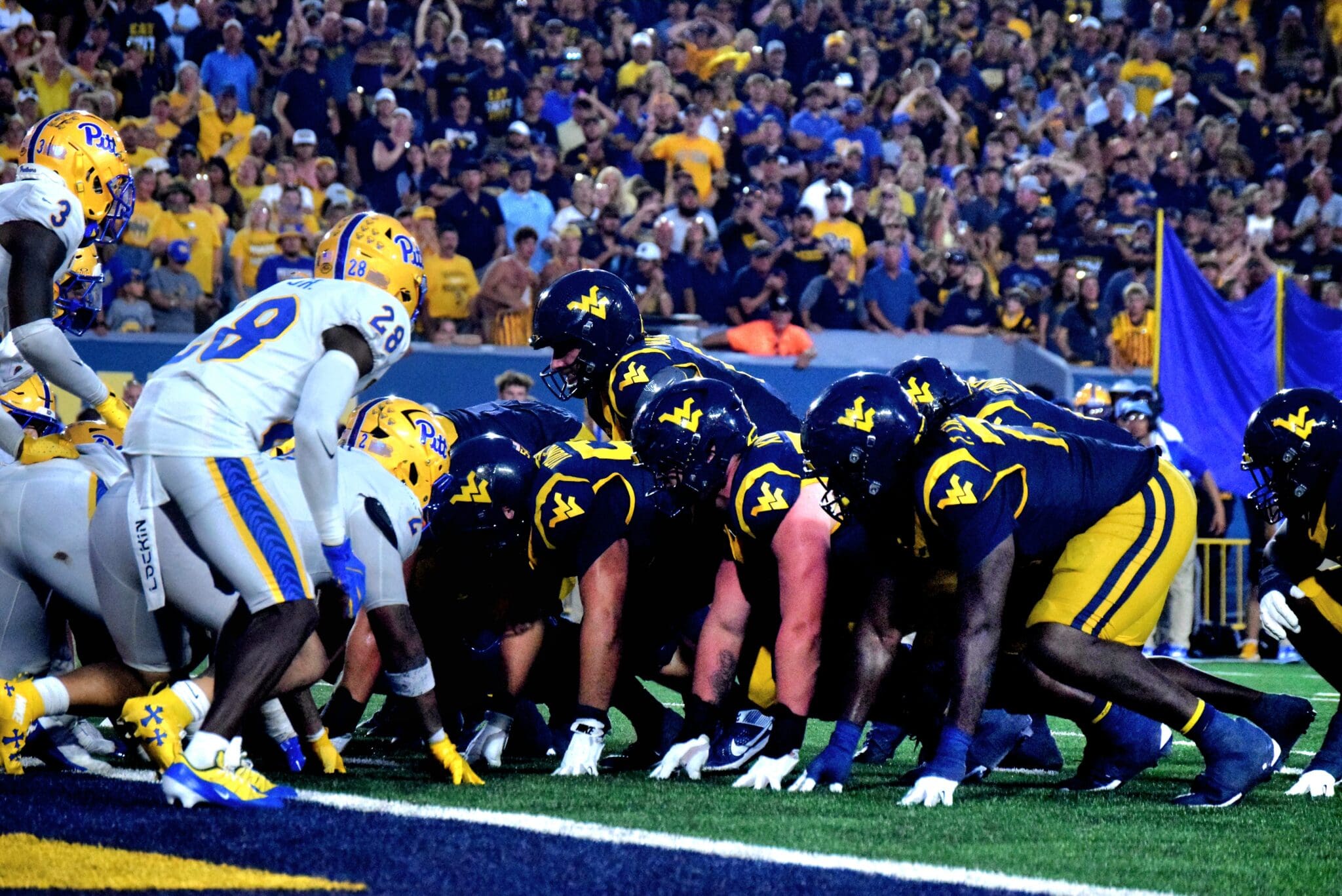 WVU Football offense lines up near end zone against Pitt in Backyard Brawl