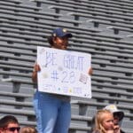 Family of WVU Football player with sign