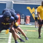 WVU Football defensive lineman stretching at practice