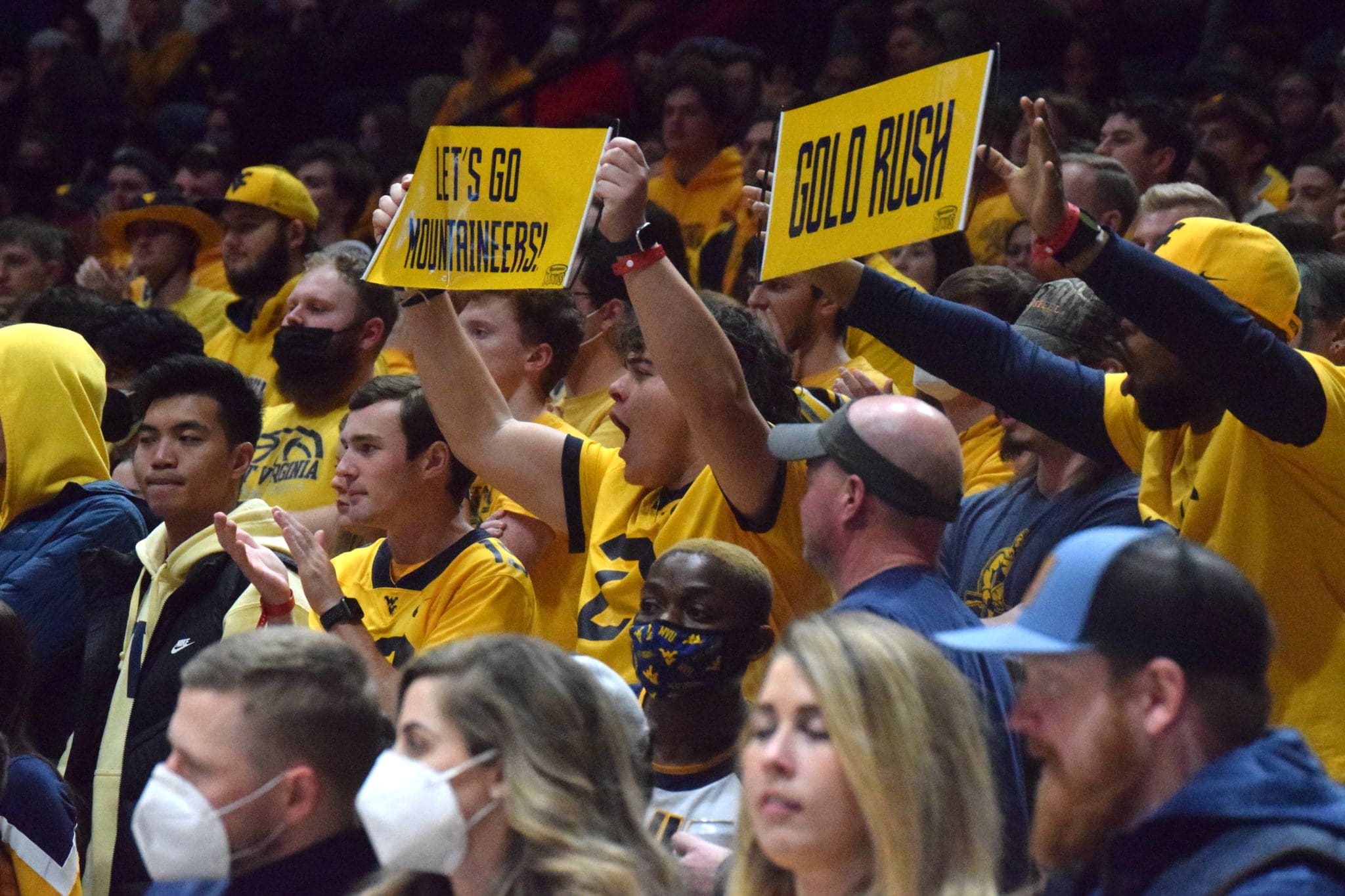 WVU Basketball Fans with Gold Rush sign