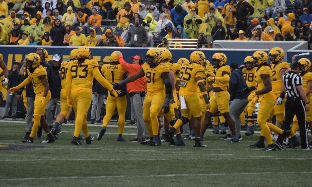 WVU Football Defense congratulates each other