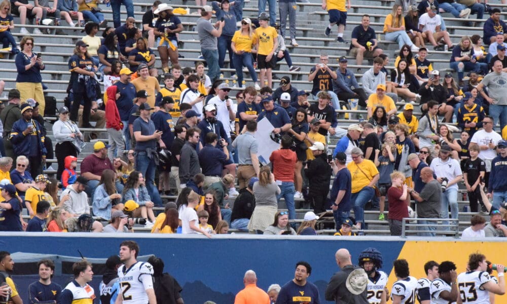 WVU Football Rich Rodriguez in stands with fans during spring showcase