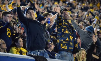 WVU football fans signal for a first down