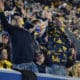 WVU football fans signal for a first down