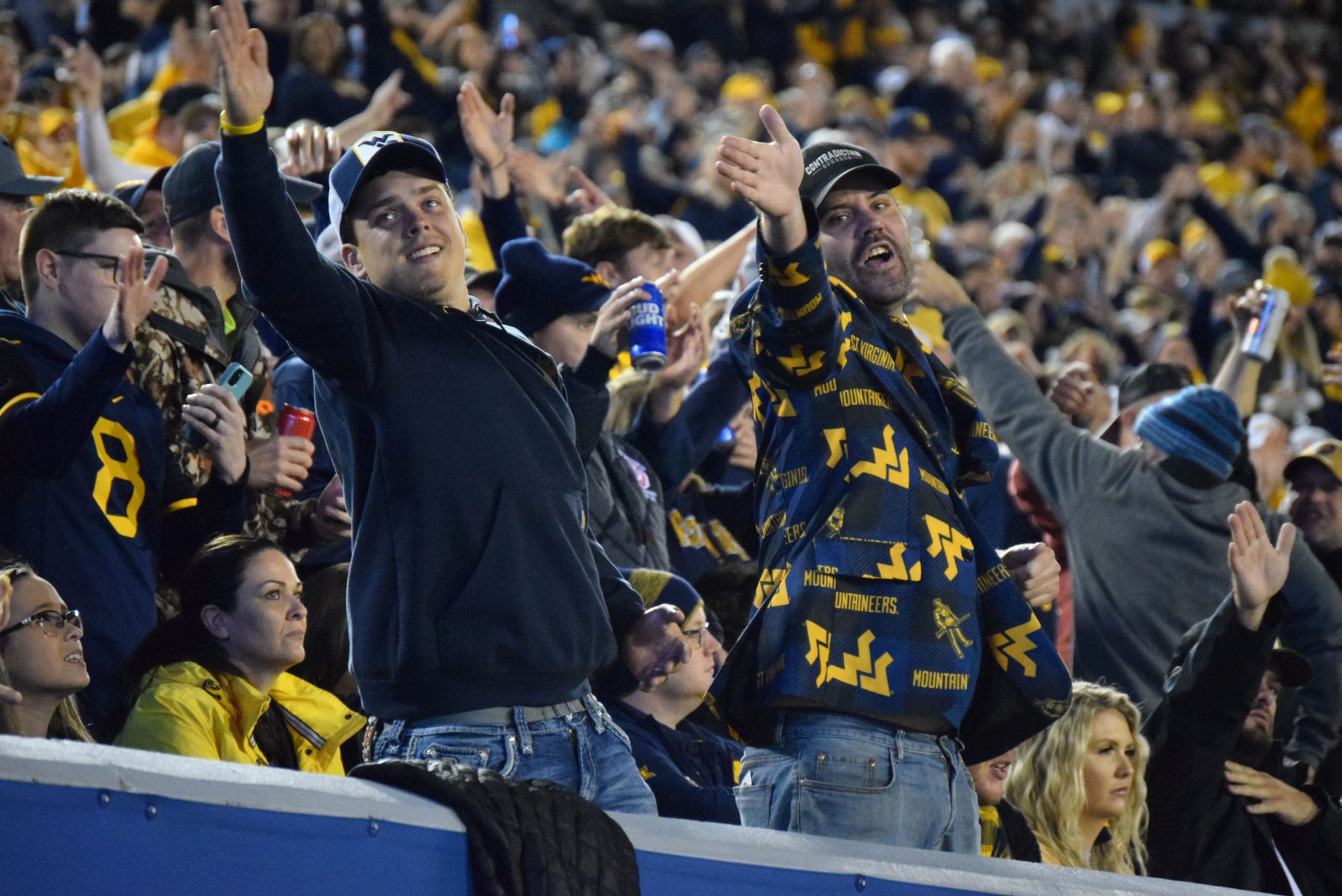 WVU football fans signal for a first down