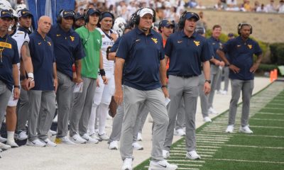 WVU Football HC Rich Rodriguez and coaches on the sideline