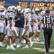 WVU Football HC Rich Rodriguez in huddle with players and Michael Hawkins